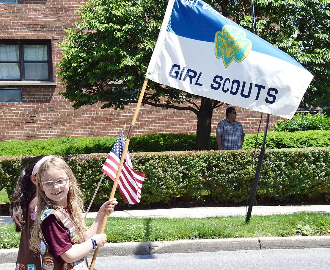 A member of Troop 2098, King Street School third-grader Arianna Butkiewicz waves the Girl Scout flag with pride during the procession.