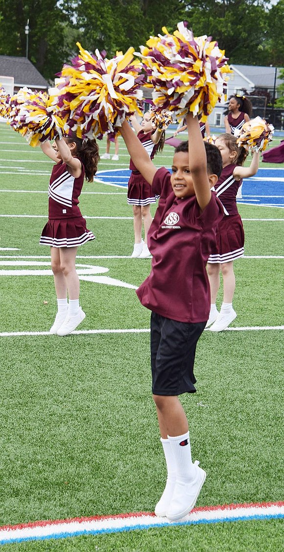 First grader Sabastian Murphy dances and shakes his pom-poms with the King Street School spirit squad.