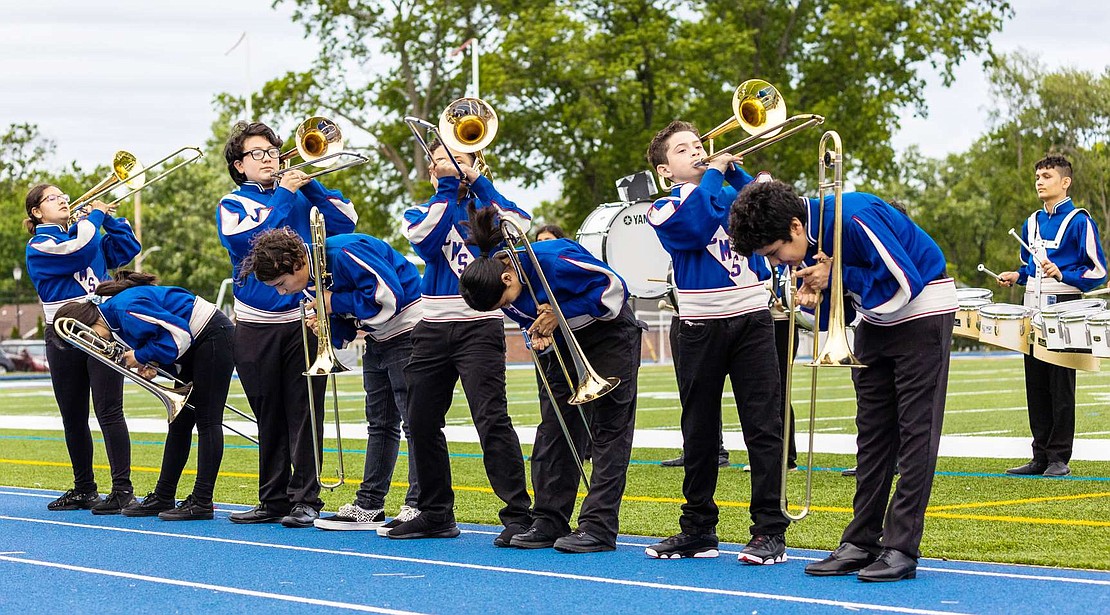 Port Chester Middle School band students from all three grades play the tricky “Trombone Suicide.” Standing, from left, are Mariangel Osorio (8), Jesus Mora Vega (7), Dylan Villa (7), Aaron Orozco (6) and bending over, from left, are Katherine Ramos (7), Sebastiano Anzovino (7), Brenda Ramirez (6), Jesus Vargas (6). Accompanying them in the back is quad drummer Pedro Villanueva (7).