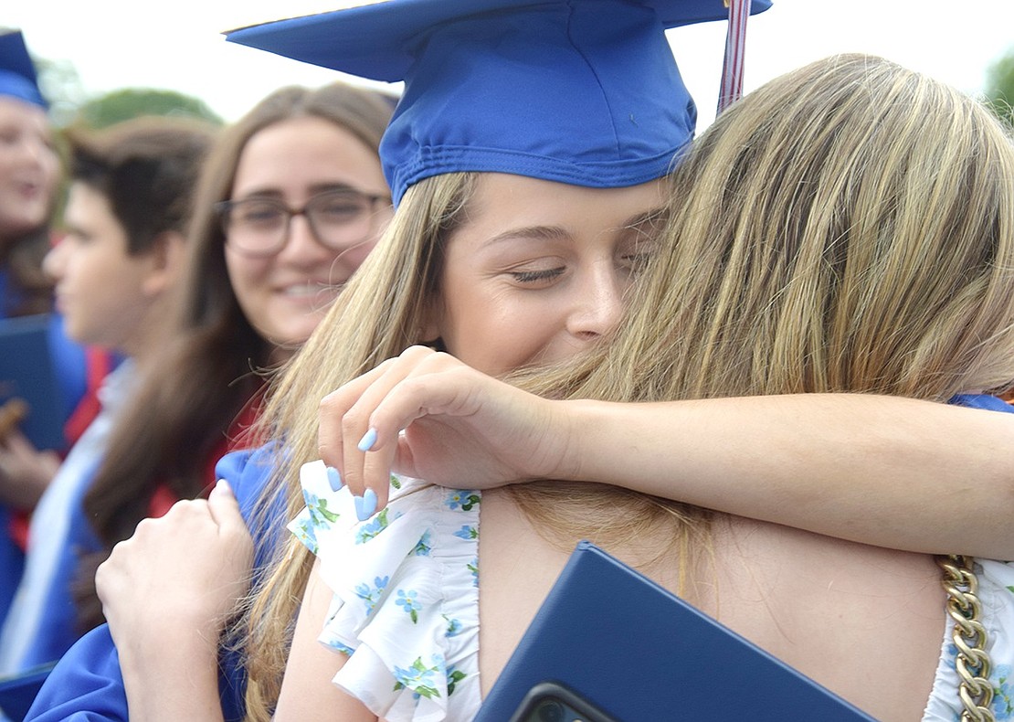 Blind Brook High School junior Talia Levy approaches Class of 2022 graduate Shira Mallah with tears in her eyes just after the commencement ceremony on Thursday, June 23, and the new alumna responds with a smile and embraces her friend.