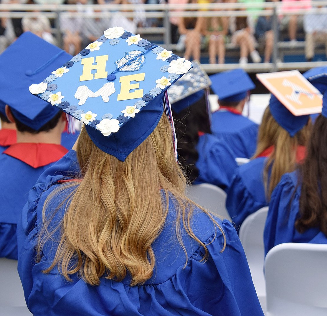 Julia Zislis sits as one of many in the Class of 2022 who took the time to decorate her cap elaborately and tastefully for graduation.