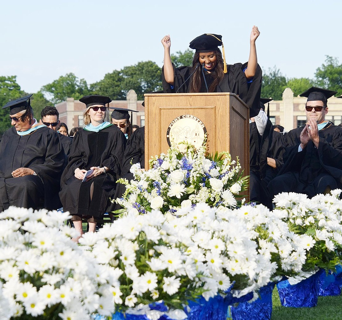 Giving her first commencement address as superintendent of Port Chester Schools, Dr. Aurelia Henriquez throws her hands in the air with excitement while addressing the Class of 2022.