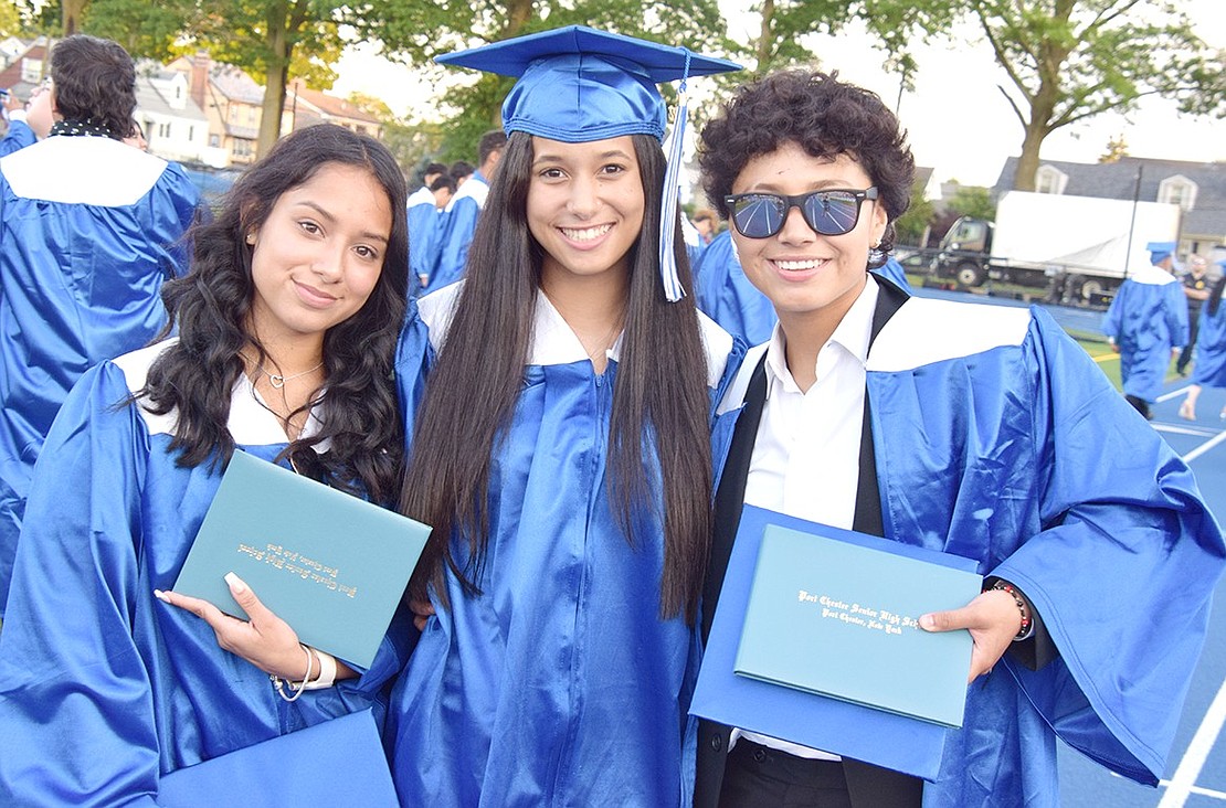 They did it! Before meeting with friends and family after the ceremony, graduates Samantha Mendoza (left), Keyla Sepulveda and Aracely Monroy pose for a photo  .