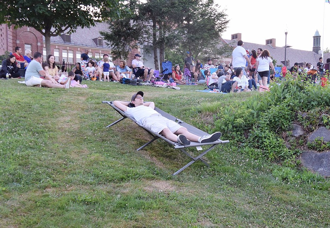 Stretched out on a cot on the grassy area to the left of the bleachers at Ryan Stadium, Matthew Bauer of Washington Street prepares to watch the skydiver and fireworks in complete comfort. No neck craning required!