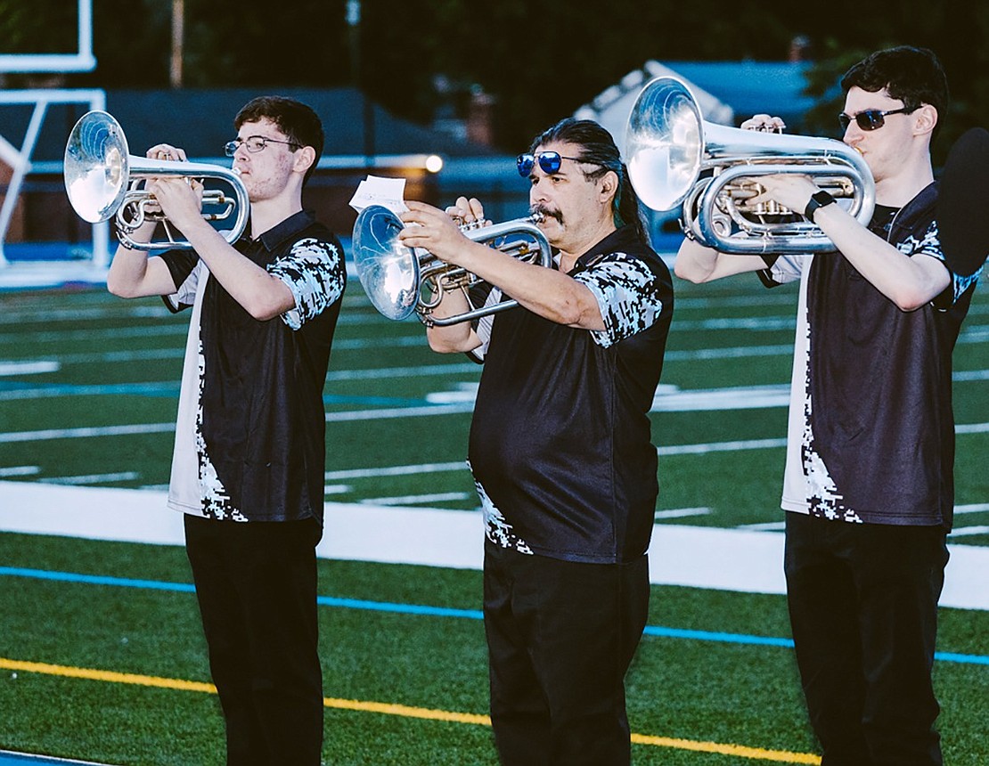 After the skydiving demonstration, Josh Feldman (left), Roy Lespier and Andrew Feldman play patriotic tunes on mellophone with a small group of musicians representing the Westchester Brassmen.