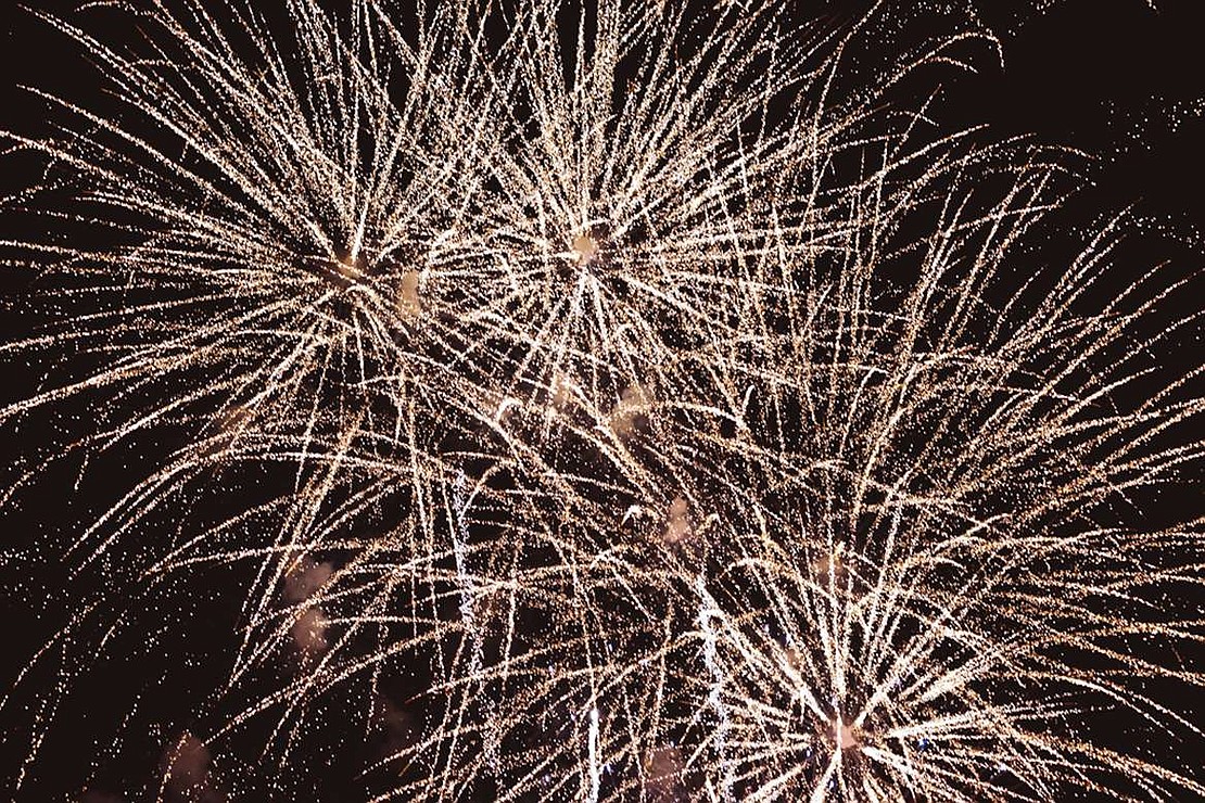 Fireworks create a silver and gold effect.