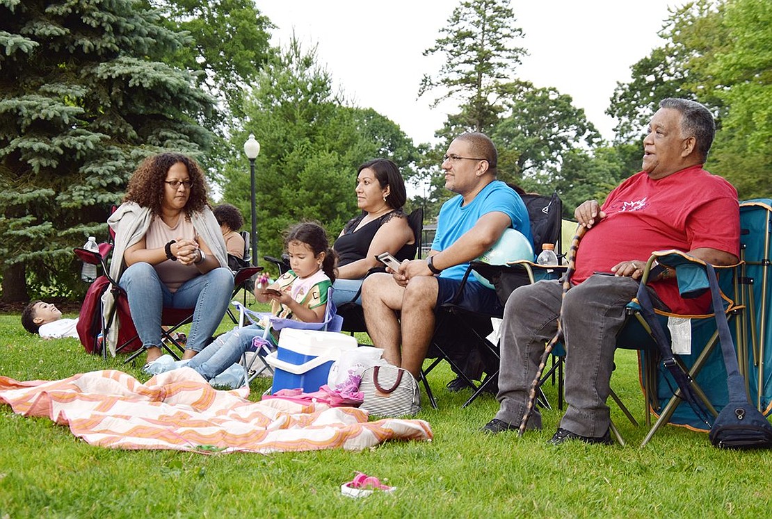 Delilah Lora (left), Jacqueline Arez, Luis Arez and Pedro Urena watch Goza’s bongo player, a relative of theirs, perform. The group traveled from the Bronx to see the concert last Friday.