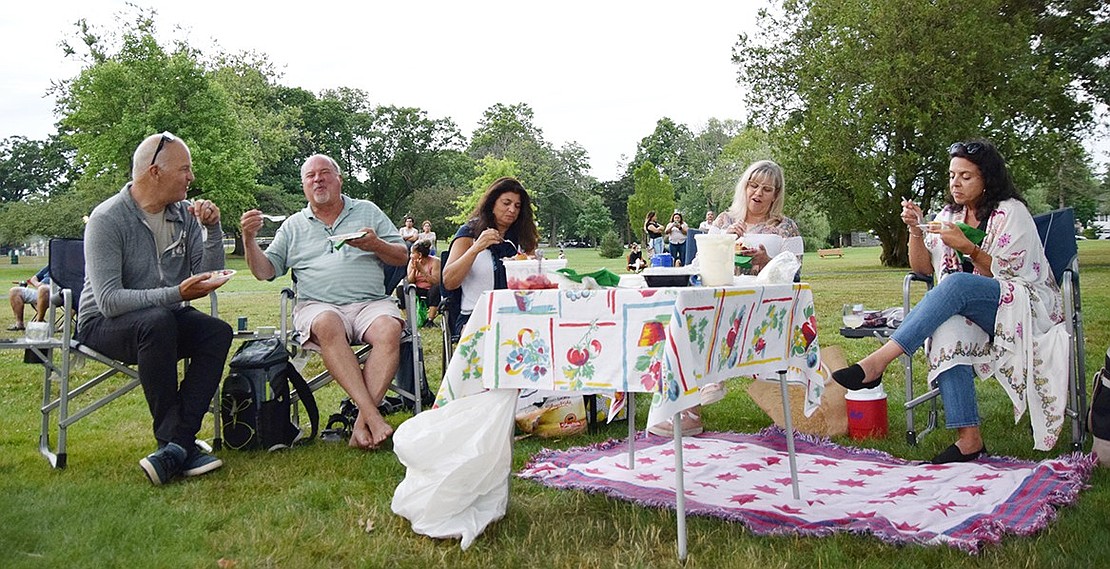 Jeff Johnson (left), Jim Ferreira, Jackie Ferreira, Laura Fraser and Linda Kavanagh picnic as they enjoy the show. Johnson and Fraser visited from Washington State, while the Ferreiras are from Greenwich, Conn., and Kavanagh is from Stamford, Conn.