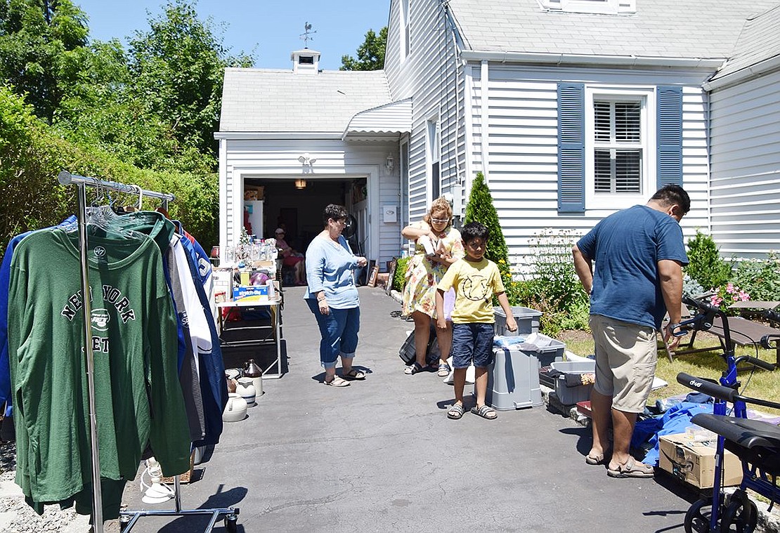 Sdencka and Juan Suarez of Port Chester and their son Zack, 9, peruse the merchandise for sale at the home of Lorraine Martire (back left) at 23 Maywood Ave. on Saturday afternoon, July 23. Martire’s was one of 13 addresses participating in the second Rye Brook Community Tag Sale that day in addition to six residents and non-profits that set up tables at 62 Bowman Ave., the home base of Foster Teen Employment Network. Despite the heat, Martire said, “I did very well. I’ve had people all day long.”