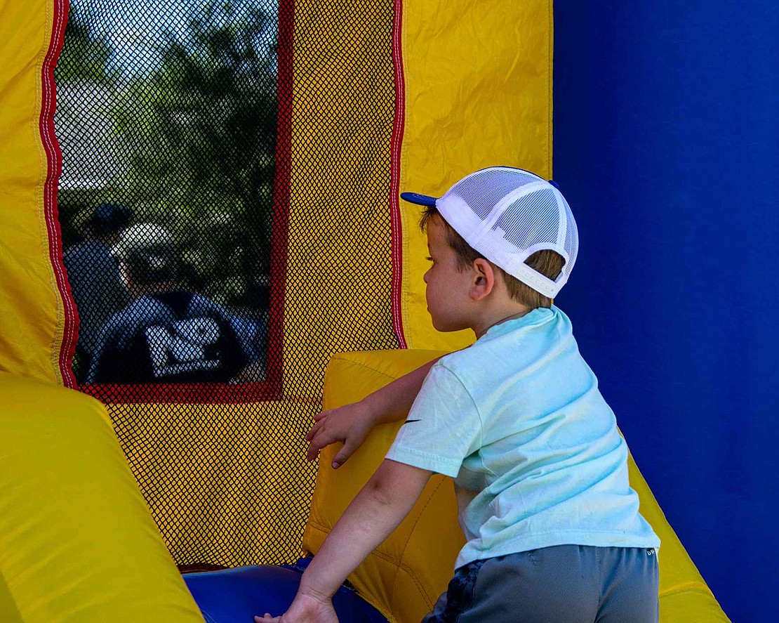 Rye Brook resident Hudson Kaplan  is ready for adventure, but bounce houses are scary places for 4-year-olds. He looks inside, swallows his nerves and prepares to jump his little heart out.