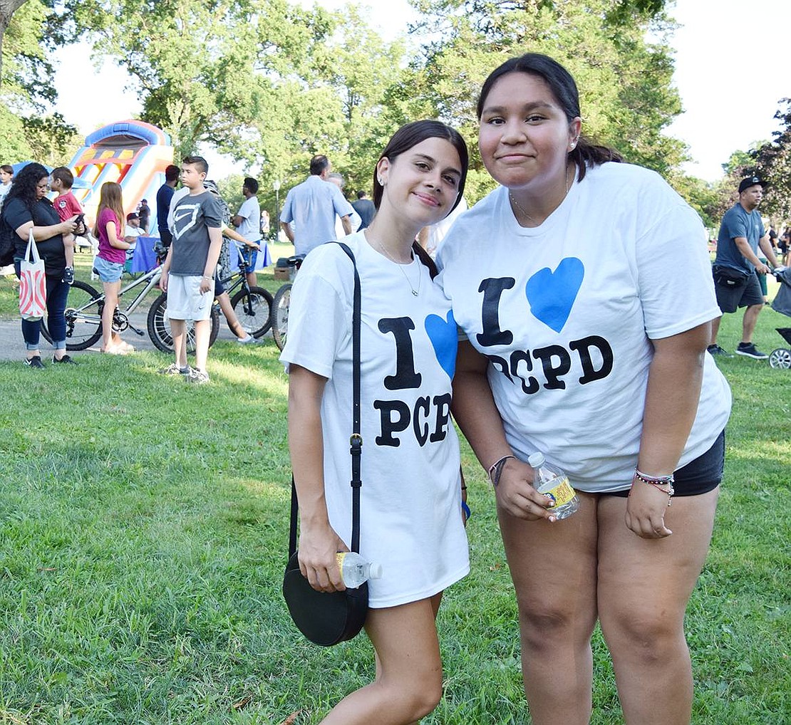 Who doesn’t love free stuff? With support for the force, soon-to-be Port Chester High School juniors Sofia Larizza (left) and Stephanie Nunez proudly sport their new “I heart PCPD” T-shirts, a popular giveaway item at the event.