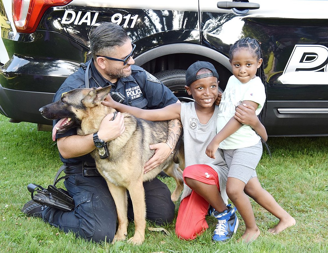 Beacon residents who think of Port Chester as their second home due to their father Rev. Patrice Kemp’s presence as pastor of St. Frances AME Zion Church, Dominic Lide, 8, and his sister Ky-Leah, 4, are eager to meet K9 Officer Mac. As Mac’s handler, Officer Marcelo Pereira adoringly watches over their interaction.