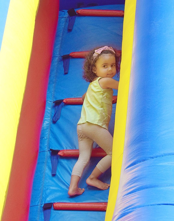 On the long, scary trek up the ladder to the top of the bouncy slide, 2-year-old Valentina Sandolo of Stamford, Conn., stops to look back at her loved ones for some moral support.