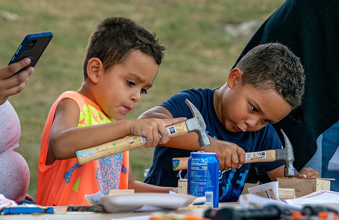 Building boxes can be backbreaking work, but Matteo Benitez (left), 4, and Jacob Recino, 5, are down for the challenge. The Purdy Avenue residents wield their crafty hammers as they make sure their projects are perfect.