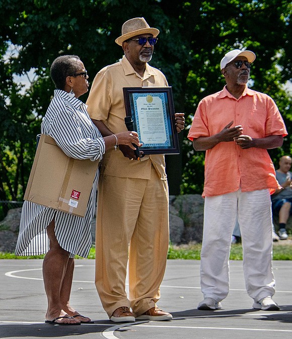 Port Chester Trustee Joan Grangenois-Thomas presents a proclamation to Fred Griffin, who stands next to his North Carolina-based brother Gregory Griffin, in recognition of his community service. Fred Griffin is an active member of the Port Chester-Rye NAACP, a Vietnam War veteran and a retired local basketball coach.