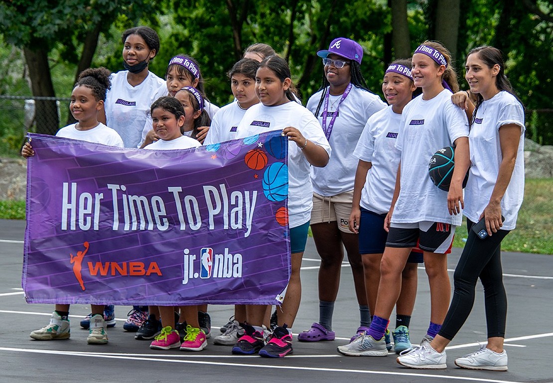 Members of two local girls’ basketball teams pose for a group photo on the Columbus Park courts. The girls were the first to play in a series of games lasting throughout Unity Day and represent the first women to play at the event.