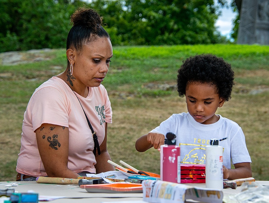 Five-year-old Supreme Jones has a vision for his project, but it’s just going to take a lot of red paint. His soon-to-be stepmother Nicole Rabb watches the Port Chester resident as he works, having traveled from Bridgeport, Conn., to attend the event with her family.