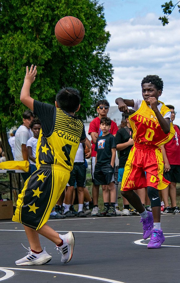 Port Chester Middle School rising seventh-grader Ryan Chuichi (front) is ready to intercept Amari Johnson’s pass, but Johnson, a soon-to-be sixth-grader from Stamford, Conn., is too quick. The ball soars over Chuichi’s head, and the red team remains in possession of the ball.