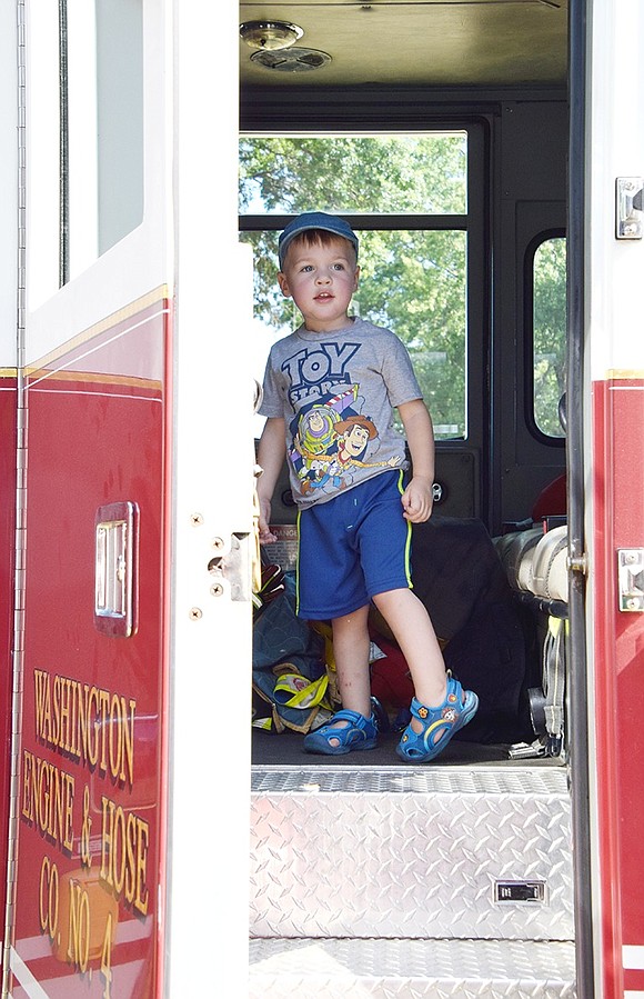 Jason Billington, a 2-year-old Port Chester resident, is in awe as he stands inside a Port Chester Fire Department engine and takes in all the complexities of the Washington Engine & Hose Co. No. 4 vehicle.