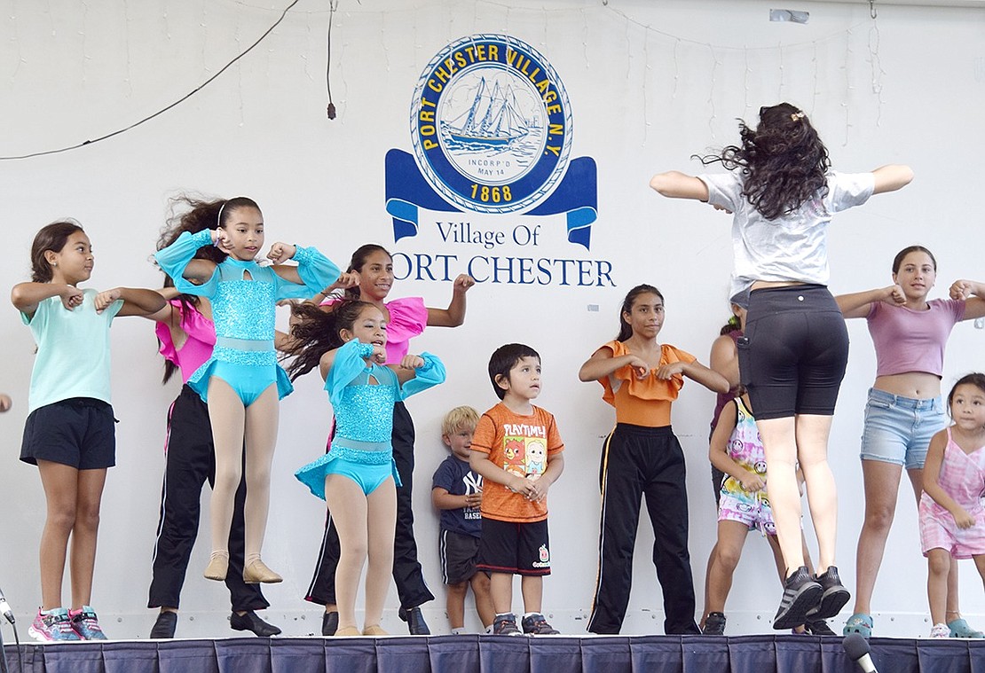 After getting the open invitation, children in the crowd join young Jeté Dance Studio dancers to learn a new routine during a quick hip-hop workshop led by Brittany Balise, a co-director and instructor with the Pearl Street organization.