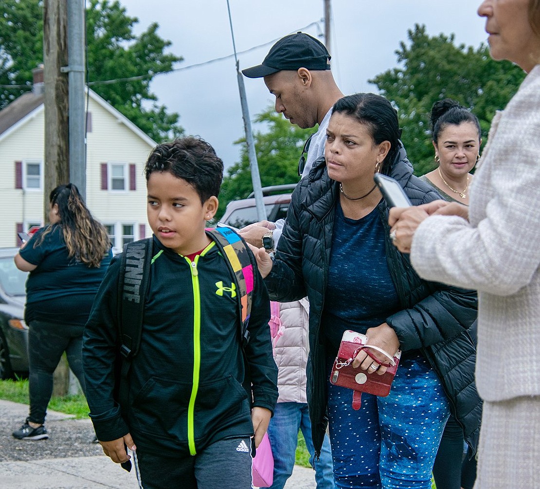 Second-grader David Dos Santos prepares to head into Park Avenue Elementary School as his mom Roselia nervously looks on.