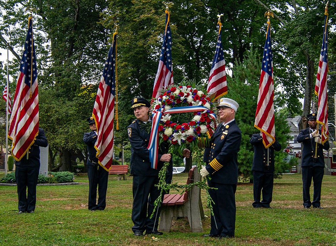 Port Chester Police Chief Chris Rosabella (left) and Port Chester Fire Chief Herbert Bocchino prepare to place a wreath at the 9/11 memorial in Lyon Park during a ceremony on Sunday, Sept. 11, an annual event, this year recognizing 21 years since the fateful terrorist attacks.