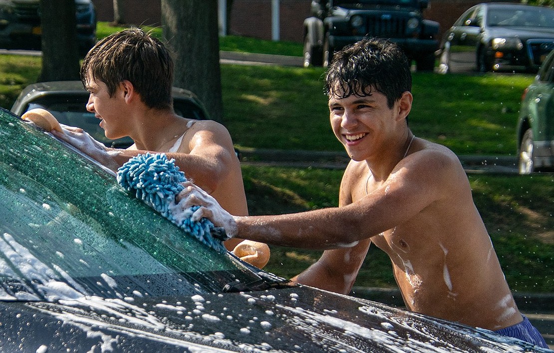 Blind Brook boys’ varsity soccer junior midfielder Martin Otero (right) and senior co-captain Nico Gonzalez, also a midfielder, scrub the hood of a car during the team’s car wash fundraiser in the Blind Brook Middle/High School parking lot on Saturday, Sept. 17.