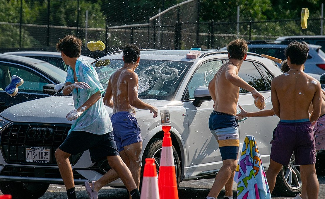 Who said washing cars has to be all work and no play? Certainly not the Trojans, who throw sponges at the cars they wash—and at each other.