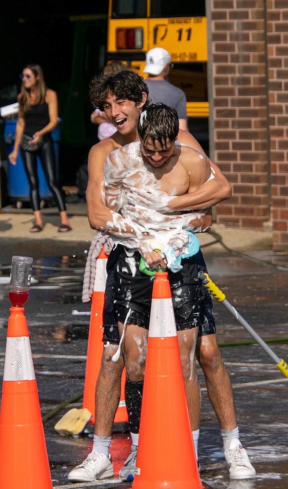 Team co-captain Jack Sassower, a senior defenseman, hugs fellow co-captain and senior midfielder Nico Gonzalez, covering him in suds in the process.