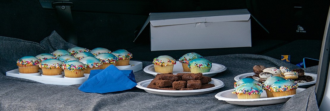 Cupcakes, brownies and cookies sit in the back of an SUV, ready to feed a team of hungry Blind Brook boys’ soccer players after they finish washing cars. The treats were made by one of the boy’s moms.