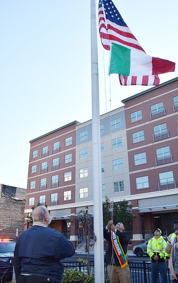 After the gathering at Columbus Park on the morning of Oct. 9, Mayor Luis Marino, who was grand marshal of the Columbus Day Parade later that day, raises the Italian flag in Liberty Square which will fly for the month of October.