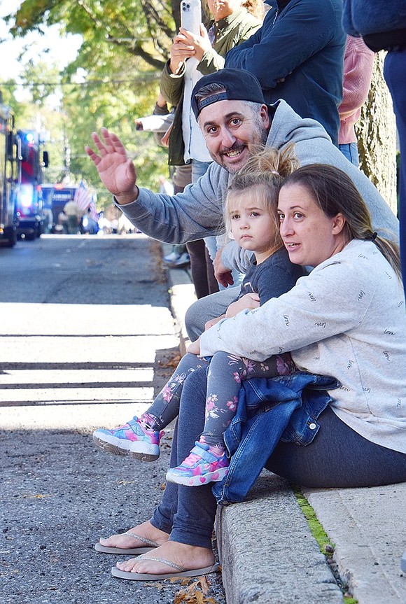 Fire engines are loud, especially when they blare their horns. Port Chester residents Taryn and Mike Tedesco try to comfort and excite their mildly concerned 2-year-old daughter Eva as the trucks pass by.