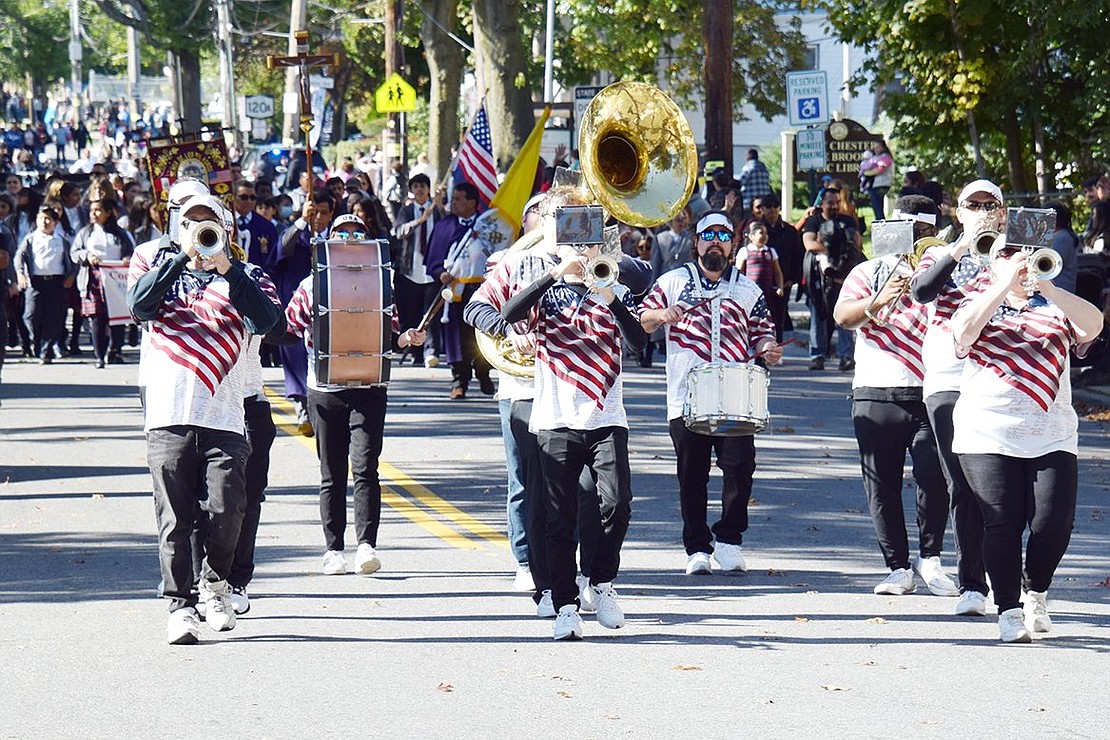 Hordes of marchers follow The Tappan Zee Bridgemen as they have a jolly ol’ time parading through Port Chester. 