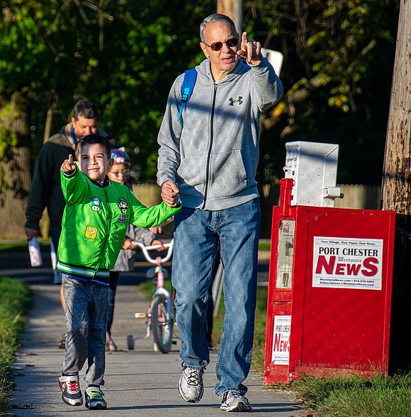 Gianni Patafio holds the hand of his grandfather Greg Woods as the two point out scenery while strolling to Gianni’s first-grade class at King Street Elementary School the morning of Wednesday, Oct. 12 for International Walk to School Day.