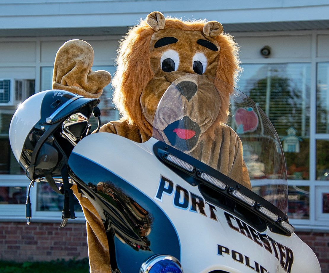 King Street Elementary School’s mascot, Roary the Lion, sits on a Port Chester Police Department motorcycle, which was brought to the event for photo opportunities and so officers could educate students about police work.