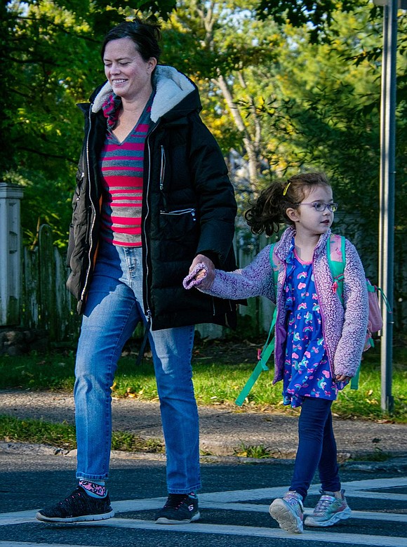 Amanda Mercaldi walks her daughter Cora to her kindergarten class at King Street Elementary School. The Hawley Avenue residents cross King Street on their way.