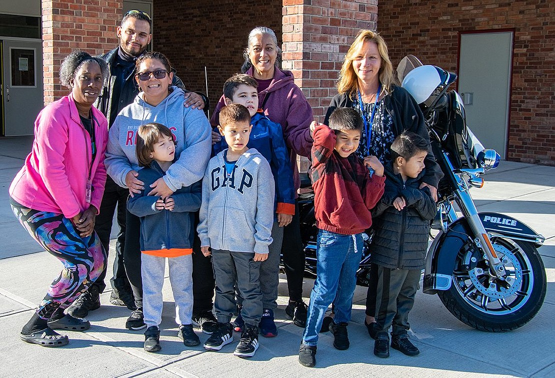 Students in Lissette Hernandez’s special education class pose for a picture in front of the Port Chester Police Department’s motorcycle, manned by Officer David Arroyo (back left).