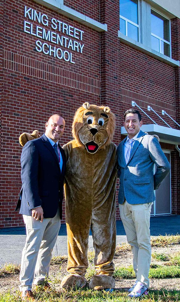 King Street Elementary School Assistant Principal Anthony Carolini (left) and Principal Sam Ortiz stand with the school’s mascot, Roary the Lion, after another successful Walk to School Day.