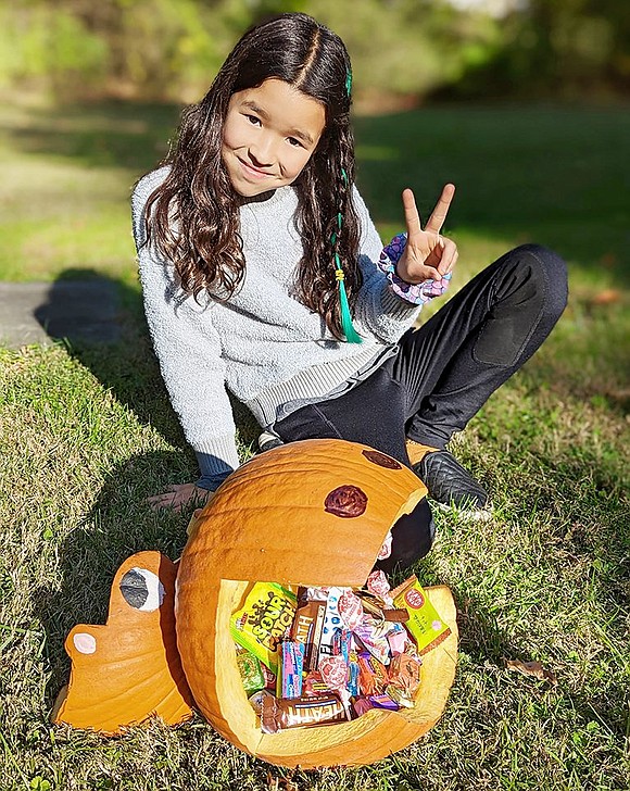 Sakura Murray, 9, of Windingwood Road, with her hippo pumpkin that was a runner-up in the Rye Brook pumpkin decorating contest. Courtesy of Village of Rye Brook 