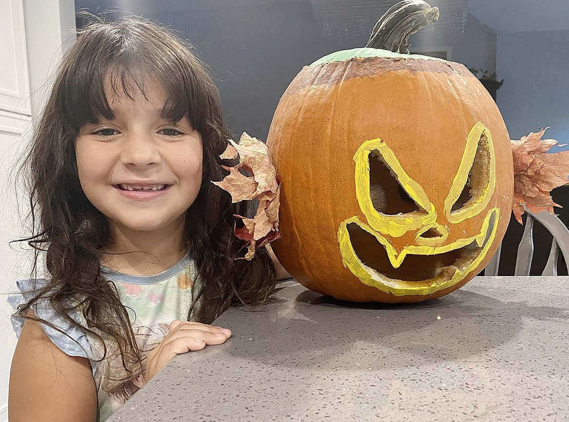 Samantha Mutis, 6, of Hunter Drive, with her spooky pumpkin that was a runner-up in Rye Brook’s pumpkin decorating contest.  Courtesy of Village of Rye Brook 