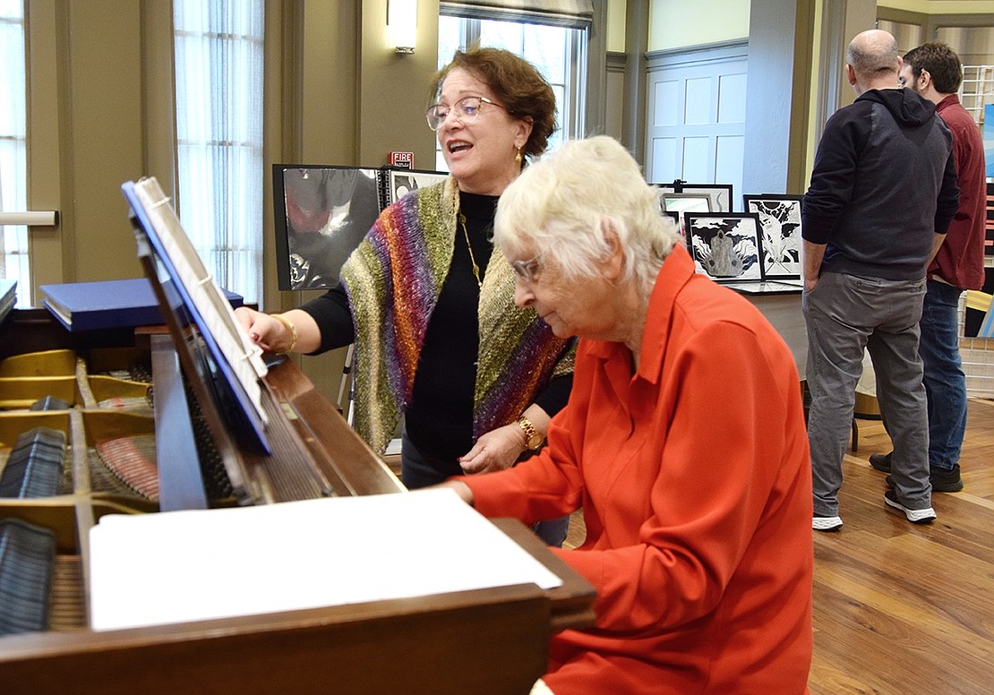As art-lovers stroll around the Crawford Mansion Community Center, Rye resident Donna Cribari provides musical ambiance on the piano, playing “Beauty and the Beast” while Rye Brook resident Claudia Levy sings along.