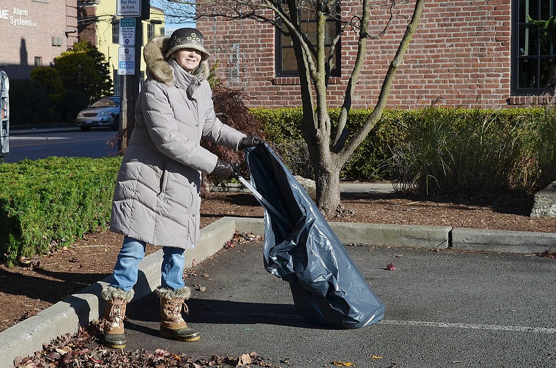 All bundled up on a cold and windy day, Alison Nicholls, a member of the Port Chester Sustainability Committee, picks up trash in the Marina Parking Lot during Port Chester’s Community Cleanup Day in collaboration with other communities in Rye Town on Sunday, Nov. 20.