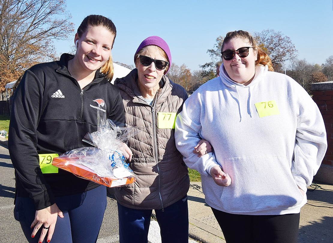 Terry Heller, 88, of Glen Avenue was the oldest Turkey Trot participant. She is flanked by grandchildren Kelly Hyland and Julie Tiedemann of Rye. The Tiedemanns won the prize for having the most family members (6) taking part, an award they have often won in the past.