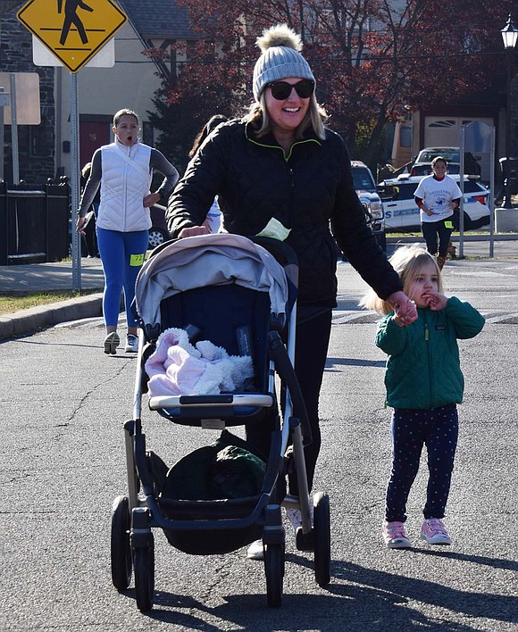 Katie Kessler of Robert Avenue pushed her daughter Teagan, 2½, in her stroller until the end of the run when Teagan got out to cross the finish line on her own two feet.