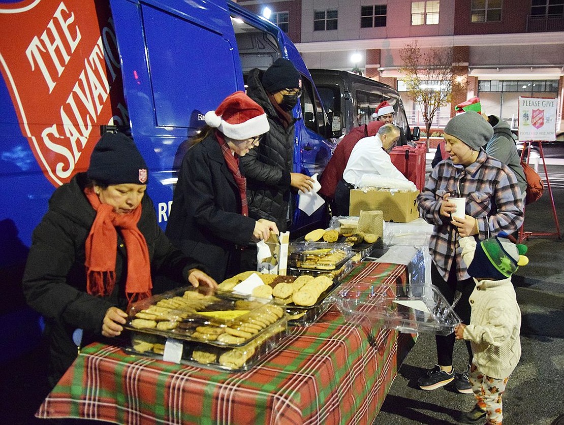 Diana Delgado and her son Manuel Tobar, 3, of Oak Street partake of the cookies and hot chocolate distributed by the Port Chester Salvation Army. 