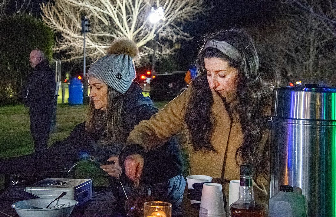 Zoe Spiegel (left) and Theresa D’Amico of Blanc, a Westchester-based mobile taphouse, serve drinks to cold and eager customers behind the Crawford Mansion Community Center.