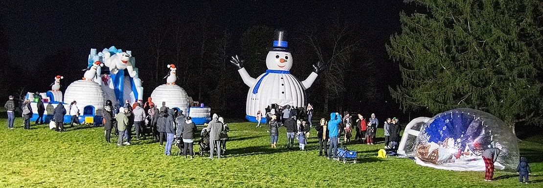 Penguins, polar bears and a large snowman greet families with young children eager to jump in the bounce houses to which they’re attached.