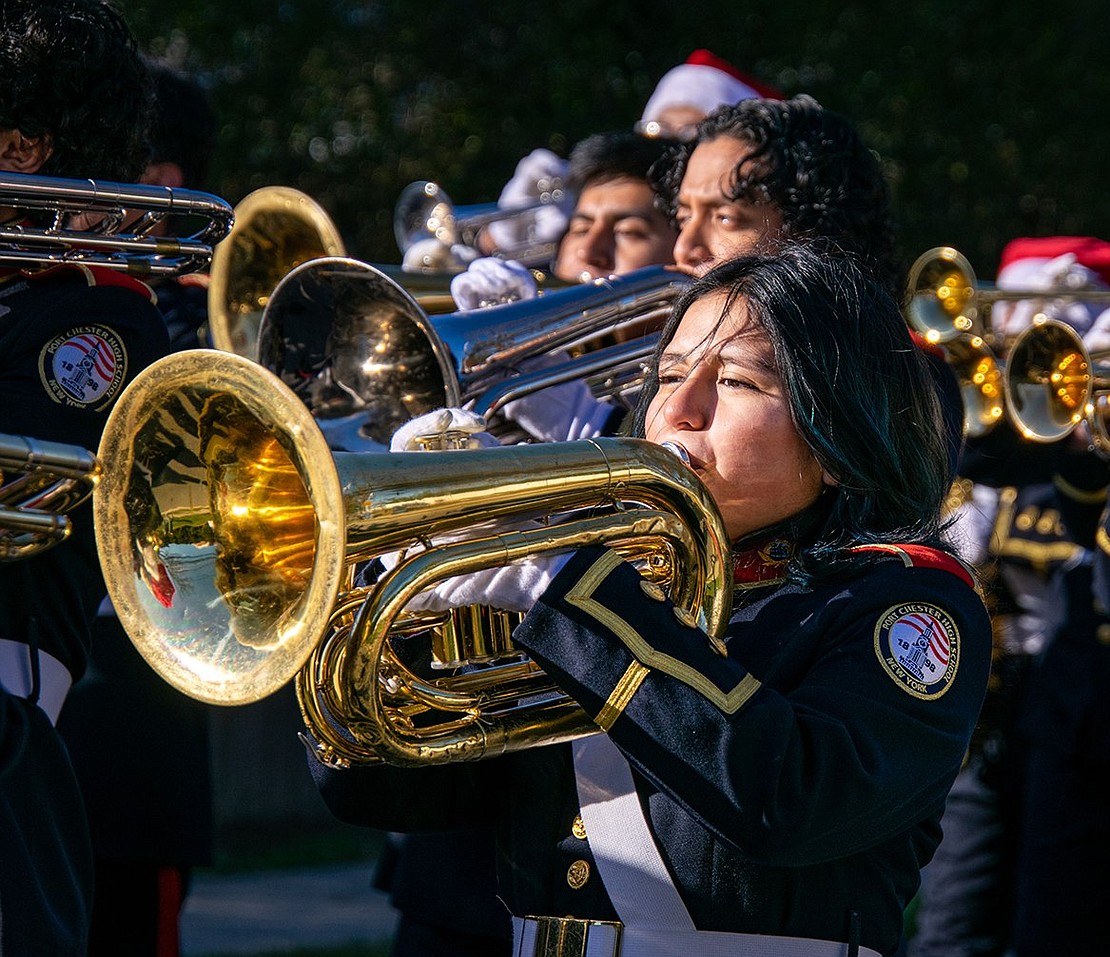 Baritone player Juliana Mercado, a senior, performs holiday music with the rest of the Pride of Port Chester during the annual Christmas Parade.