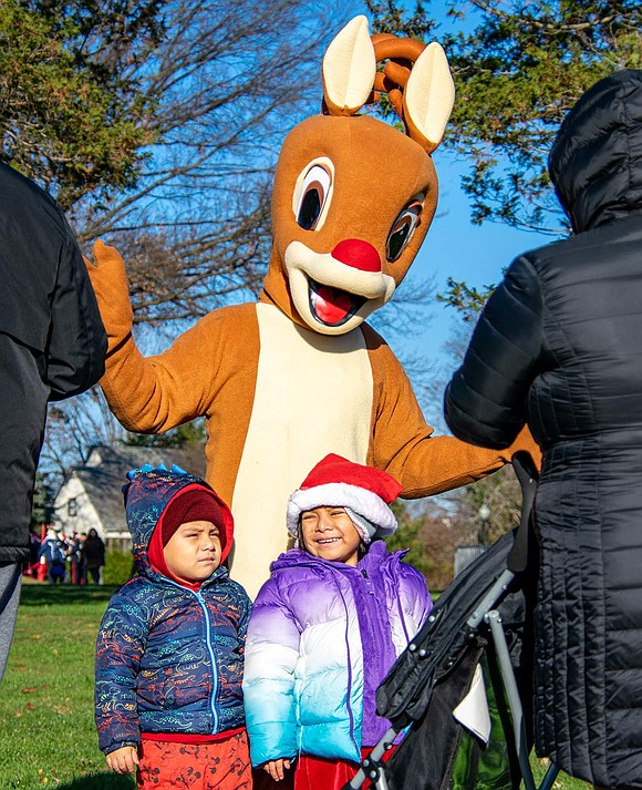 Benito Cruz, 3, poses with his 4-year-old sister Luciana for pictures with Rudolph the Red-Nosed Reindeer. The Touraine Avenue residents were ecstatic to see the character in real life.