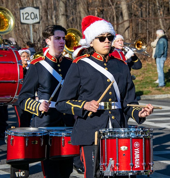 Senior snare drummer Matthew Vintimilla taps out a beat during a Christmas song the Port Chester High School Marching Band performs. Behind him, junior Trevor Sullivan plays the quads.